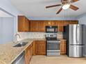 Updated kitchen with wood cabinets, granite counters, and stainless steel appliances at 4045 Arrowwood Ct, Palm Harbor, FL 34684