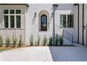 Elegant entryway featuring an arched doorway and detailed brickwork at 4633 W Lowell Ave, Tampa, FL 33629