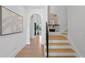 Bright foyer with hardwood floors, staircase, and arched entryways at 4633 W Lowell Ave, Tampa, FL 33629