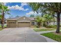 House exterior showcasing a three-car garage and landscaping at 10645 Plantation Bay Dr, Tampa, FL 33647