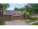 House exterior showcasing a two-car garage and stone accents at 10645 Plantation Bay Dr, Tampa, FL 33647
