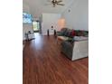 Bright living room with wood-look floors, comfortable seating, and a view to the entryway at 1912 Blue Sage Ct, Brandon, FL 33511