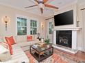 Bright living room with a fireplace, large windows, and hardwood floors, creating a cozy and elegant atmosphere at 3106 W Bay Villa Ave, Tampa, FL 33611
