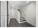 Inviting entryway featuring neutral walls, tile flooring, and a staircase to the upper level at 403 S Oregon Ave, Tampa, FL 33606