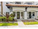 Close-up of a townhouse exterior with a distinctive red tile roof and lush greenery at 403 S Oregon Ave, Tampa, FL 33606