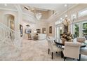 Open concept dining area with a large table and high ceilings at 602 Guisando De Avila, Tampa, FL 33613