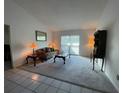 Spacious living room featuring a plush sofa and large window at 1309 Peachfield Dr, Valrico, FL 33596