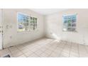 Bright living room with tile flooring and large windows at 1512 Hillside Dr, Tampa, FL 33610