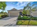 Two-story home with a two-car garage and palm trees at 27133 Ipswich Dr, Englewood, FL 34223