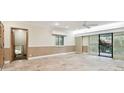 Spacious living room with tile flooring, neutral walls, and sliding glass doors to the outdoors at 36750 Us Highway 19 N # 03127, Palm Harbor, FL 34684