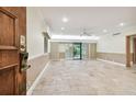 Living room with tile floors, sliding doors, and access to patio at 36750 Us Highway 19 N # 03127, Palm Harbor, FL 34684