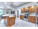 Spacious kitchen with an island, stainless steel appliances, and wood cabinets at 4948 Willow Ridge Ter Ter, Valrico, FL 33596