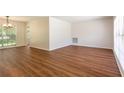 Bright and airy living room features new wood-look flooring and fresh neutral paint at 514 Crestover Dr, Temple Terrace, FL 33617