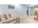 Bright and airy entryway with a bench, decorative pillows, and access to other rooms at 555 Calico Scallop St, Ruskin, FL 33570