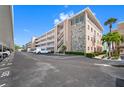 Exterior view of a multi-story condo building with stone accents and well-maintained landscaping at 6363 Gulf Winds Dr # 437, St Pete Beach, FL 33706
