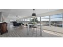 Living room features hardwood floors, large windows and city views at 6363 Gulf Winds Dr # 437, St Pete Beach, FL 33706