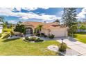 Beautiful home with well-maintained landscaping and a two-car garage at 719 Winterbrooke Way, Sun City Center, FL 33573