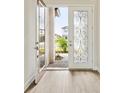 Elegant front door with decorative glass panel opens to a bright and inviting home at 13110 Homestead Ln, Parrish, FL 34219