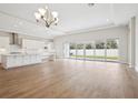 Bright, airy living room with wood floors and sliding glass doors leading to the backyard at 13110 Homestead Ln, Parrish, FL 34219