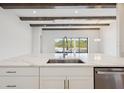 Bright, modern kitchen featuring a large island, white cabinets, and stainless steel appliances at 13804 Heartwood Way, Parrish, FL 34219