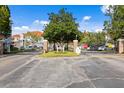 Gated community entrance with lush landscaping and ample parking at 18001 Richmond Place Dr # 734, Tampa, FL 33647