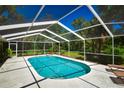 Inviting screened-in pool with lounge chairs at 3204 Stagecoach Trl, Wimauma, FL 33598
