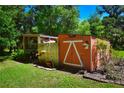Well-maintained shed and pergola in a lush garden setting at 3204 Stagecoach Trl, Wimauma, FL 33598