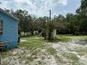 Single-wide mobile home with a blue exterior and a shed at 11911 Rhodine Rd, Riverview, FL 33579
