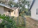 Home's side yard with chain link fence at 6408 River Ridge Rd, New Port Richey, FL 34653