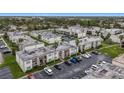 Aerial view of an apartment complex with a pool and ample parking at 7701 Starkey Rd # 324, Seminole, FL 33777