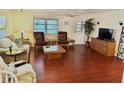 Living room with laminate floor and comfy seating at 9790 66Th N St # 208, Pinellas Park, FL 33782