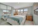 Main bedroom with mirrored closet doors and wood dresser at 122 E Saint Johns Way, Apollo Beach, FL 33572