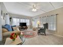 Spacious living room with comfy seating and large windows at 122 E Saint Johns Way, Apollo Beach, FL 33572