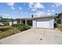 Front view of a single-story house with a carport at 7511 Tyson Dr, Port Richey, FL 34668