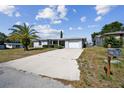 Single-story house with a driveway and palm tree at 7511 Tyson Dr, Port Richey, FL 34668