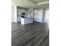 Open concept kitchen with stainless appliances, light cabinetry, and central island at 16021` 7Th E Ave, Bradenton, FL 34212