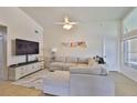 Comfortable living room with plush sofa, flat screen television, and modern decor at 311 Sugar Creek Dr, Plant City, FL 33563