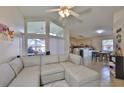 Open living room featuring a large sectional sofa, vaulted ceilings, and bright natural light at 311 Sugar Creek Dr, Plant City, FL 33563