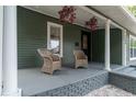 Inviting front porch with wicker chairs and hanging plants at 3506 N Arlington Ave, Tampa, FL 33603