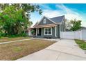 Craftsman home with a driveway and fenced yard at 3506 N Arlington Ave, Tampa, FL 33603