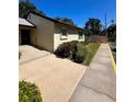 Tan house exterior with walkway and small landscaping at 4215 E Bay Dr # 1013B, Clearwater, FL 33764