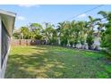 Large backyard with a wooden fence, providing privacy and space at 5419 Denver Ne St, St Petersburg, FL 33703