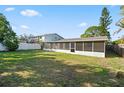 Spacious backyard with a screened-in porch and lush green lawn at 5419 Denver Ne St, St Petersburg, FL 33703