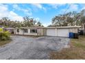 House exterior with stone facade and two-car garage at 615 16Th Nw St, Largo, FL 33770