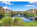 Waterfront view of condo building with fountain at 960 Starkey Rd # 2501, Largo, FL 33771