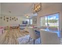 Bright dining room features a modern chandelier and sliding glass doors leading to the backyard at 20028 Satin Leaf Ave, Tampa, FL 33647