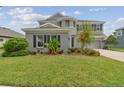 Gray two-story house with landscaping and a large front yard at 6317 Brevada Ln, Apollo Beach, FL 33572