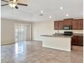 Kitchen with island, stainless steel appliances, and dark wood cabinets at 7231 Somerset Pond Dr, Ruskin, FL 33573