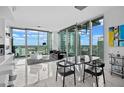 Bright open concept dining area featuring floor to ceiling windows, sleek black dining set, and city views at 777 N Ashley Dr # 2613, Tampa, FL 33602