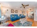 Spacious living room with blue couches and a view to the kitchen at 10036 63Rd N Ave # 23, St Petersburg, FL 33708